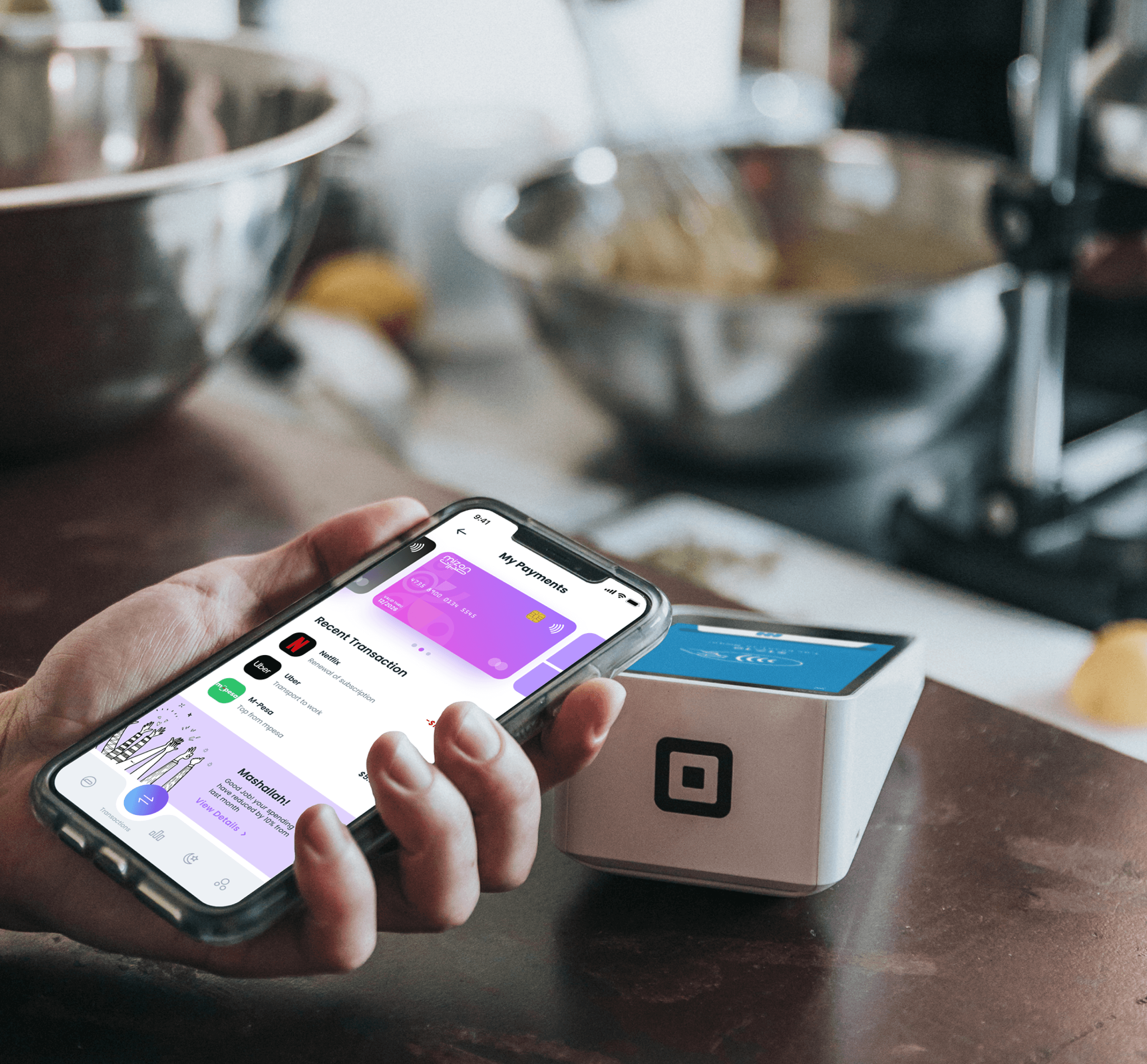Person paying with phone at kitchen counter